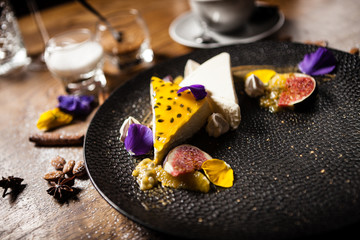 Cheesecake with passionfruit served on a plate in restaurant