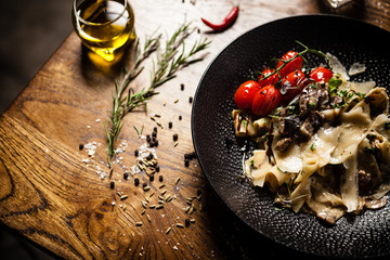 Black Angus Pasta served in a black bowl in restaurant