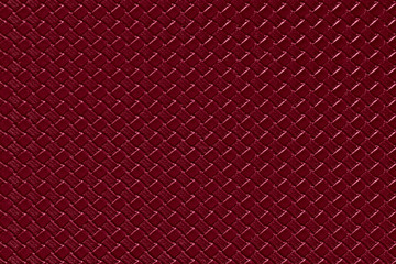 burgundy leather background with imitation weave texture. Glossy dermantine, artificial leather structure. Fake woven leather wicker textured surface.