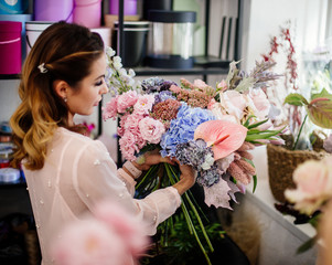 Florist woman makes a bouquet.