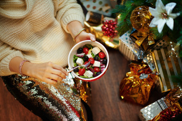 Closeup on middle age housewife eating healthy salad