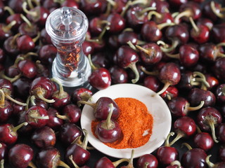 Red hot chili pepper with grinding against a dark background