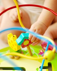 child playing with colorful toy
