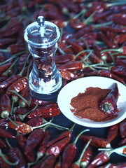 Red hot chili pepper with grinding against a dark background