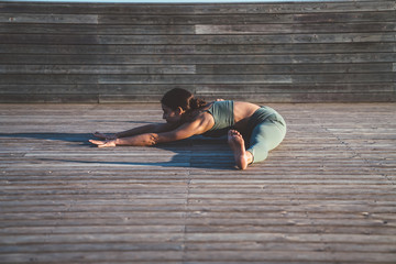 Woman sitting in seated wide legged forward bend