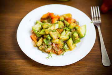 fried zucchini with red pepper, onions, tomatoes and other vegetables