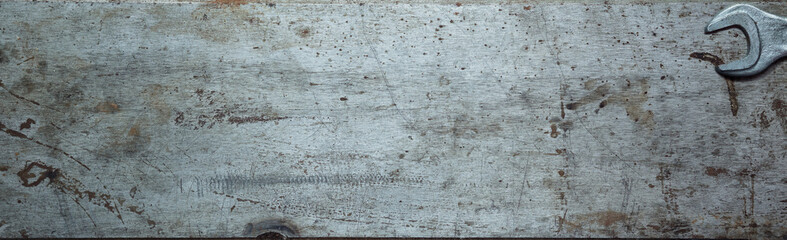 Steel textured metal sheet with rust and wrenches laid out on it. Background banner. Top view with copy space. Flat lay