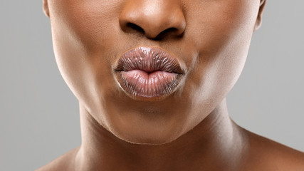 Unrecognizable black girl pouting her beautiful plump lips - obrazy, fototapety, plakaty