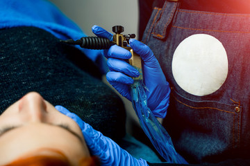 Close up on beautician preparing to do permanent make up for a woman. Beauty treatment. Closeup.