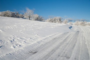 Fototapeta na wymiar snow covered street at a beautiful sunny winter day