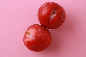 Delicious plums in colorful background