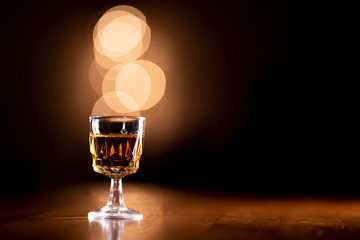 Glass of Bourbon Whiskey on a Wooden Table with Copy Space