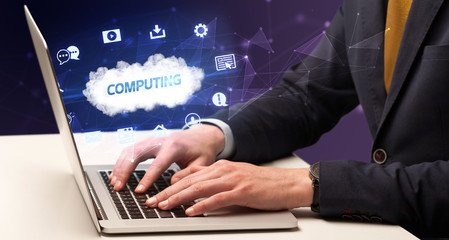 Businessman working on laptop with COMPUTING inscription, modern technology concept