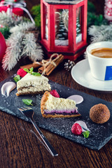Cup of coffee with christmas decorations on dark wooden table.