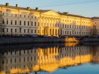 Fototapeta na wymiar Russian National Library. View from the Fontanka River at sunset. In St. Petersburg, Russia