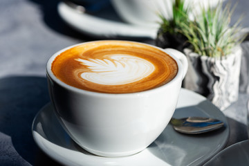 Flat white coffee on the table in the cafe