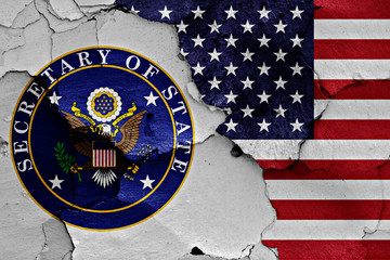 flags of Secretary of State and USA painted on cracked wall