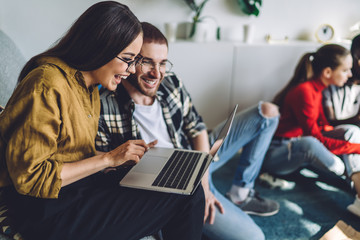 Couple using laptop and having fun