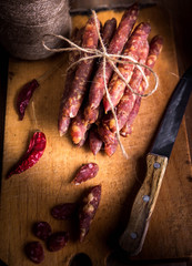 Thin uncooked smoked pork and beef sausages. Delicatessen meat.