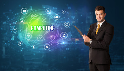 Businessman thinking in front of technology related icons and COMPUTING inscription, modern technology concept