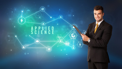 Businessman in front of cloud service icons with APPLIED SCIENCE inscription, modern technology concept