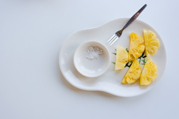 Pineapple sliced in white backdrop with copy space