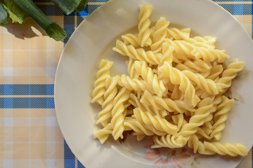 Plate of boiled pasta on the table.