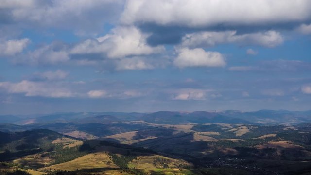Time lapse of blue sky with clouds over mountain hills. Autumn sunny day landscape nature video