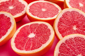 Fresh cut grapefruit on color background