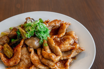 Chicken meat or pork in sauce bittersweet and greens