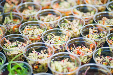 Mini appetizer salad in a glass. Traditional food for guests and participants at the event. Catering and guest services.