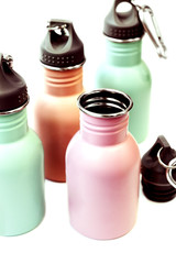 A set of safe, reusable stainless steel water bottles isolated white background