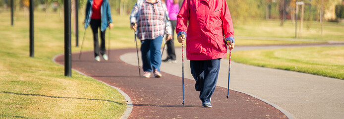 senior old people walking in the morning on the city running road, doing slow jogging for health
