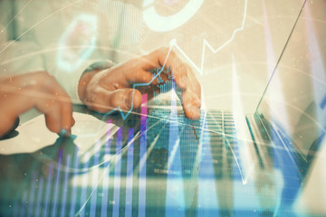 Double exposure of market chart with man working on computer on background. Concept of financial analysis.