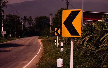 The cautionary road sign indicating a curve otherwise a straight road in Thailand