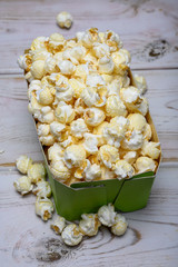 Green paper box with sweet popcorn ready to eat