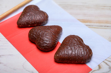 Tasty gingerbread glazed cookies from Torun, Poland and flag of Poland