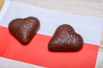 Tasty gingerbread glazed cookies from Torun, Poland and flag of Poland