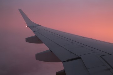 Fototapeta na wymiar wing of an airplane flying above clouds