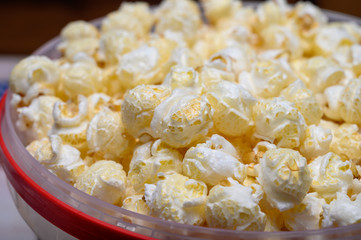 Plastic bucket with sweet popcorn ready to eat