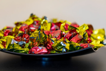 Christmas individually wrapped chocolate fondant in a bowl.