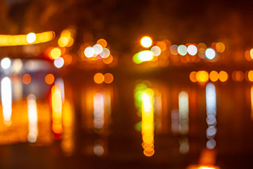 Bokeh of lights reflecting in the Ping River in Chiang Mai, Thailand