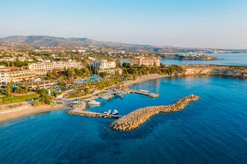 Papier Peint photo Chypre Aerial view from drone of small bay or harbor for boats and yachts in mediterranean coastline with beach and hotels on embankment at sunset, Cyprus travel concept.