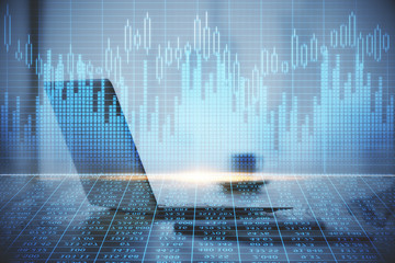 Double exposure of forex graph and work space with computer. Concept of international online trading.