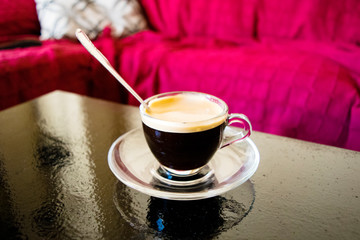 Obraz na płótnie Canvas small glass of American coffee with teaspoon