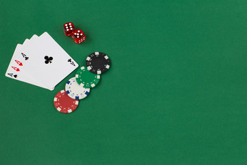 four aces, playing chips and two dice