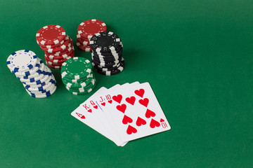 playing cards and chips are stacked in a column
