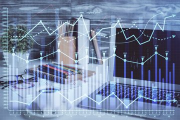 Financial market graph hologram and personal computer on background. Multi exposure. Concept of forex.
