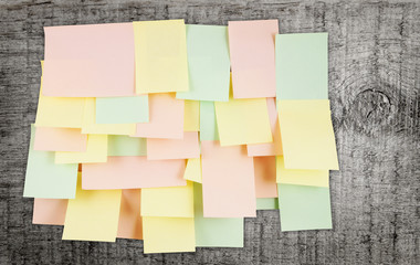 A lot of note papers on old wooden wall
