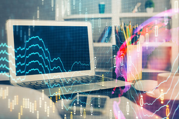 Forex market graph hologram and personal computer on background. Multi exposure. Concept of investment.